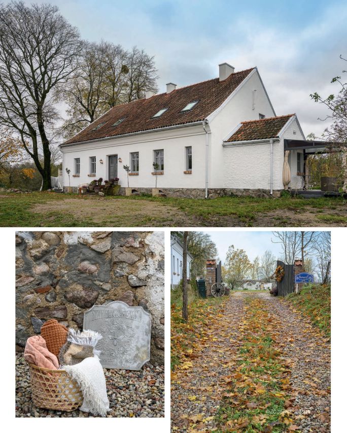 Biały wiejski dom z czerwonym dachem otoczony jesiennym krajobrazem, z detalami kamiennego muru i aleją prowadzącą do posesji.